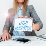 Midsection of woman using laptop at office