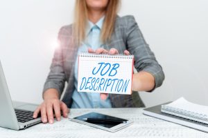 Midsection of woman using laptop at office