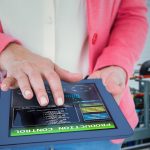 Composite image of elegant brunette using tablet