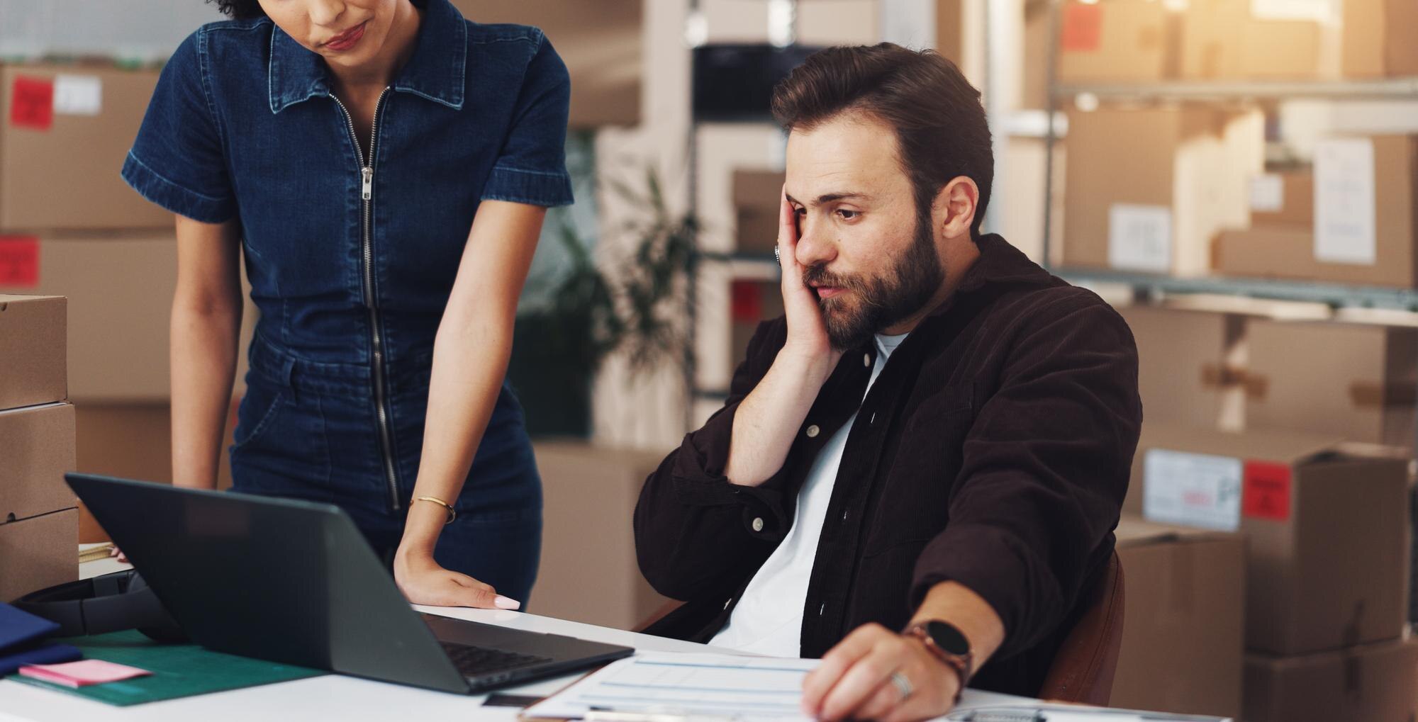 Man laptop and stress for logistics boxes and mistake with order for lost stock and woman in warehouse People computer and supply chain management with distribution error at shipping storage