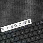 Laptop keyboard with the word Windows a specific type of operating system developed by Microsoft