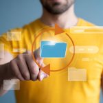 User Interacting with Digital File Management and Synchronization Interface