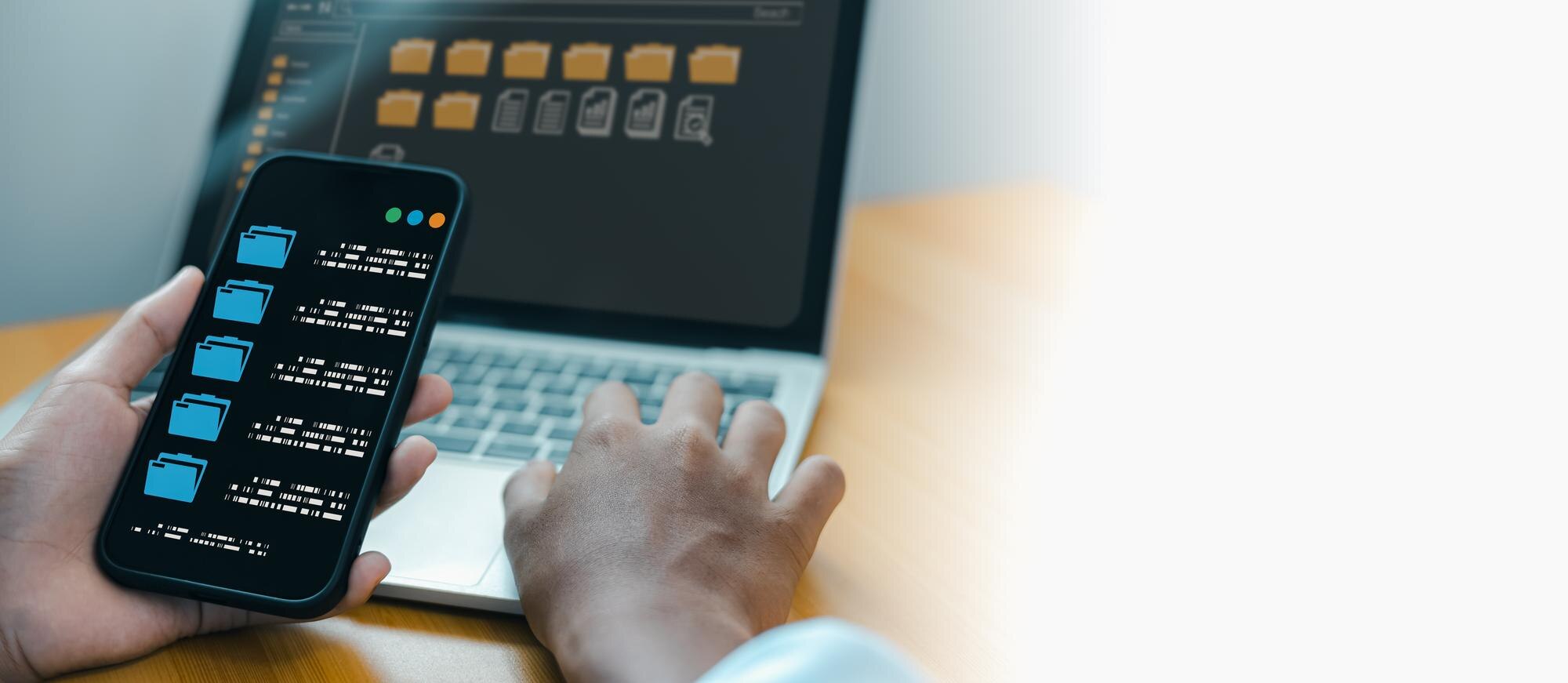 Businessman using smartphone and laptop for digital document management system